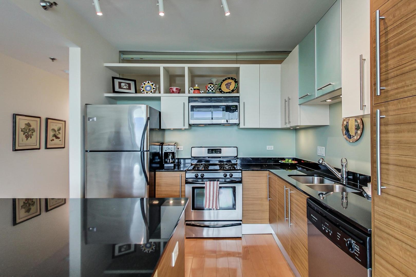 225 South Sangamon Street, Unit 809 Chicago, IL 60607 - Photo 23 of 34 a kitchen with stainless steel appliances granite countertop a stove and a refrigerator