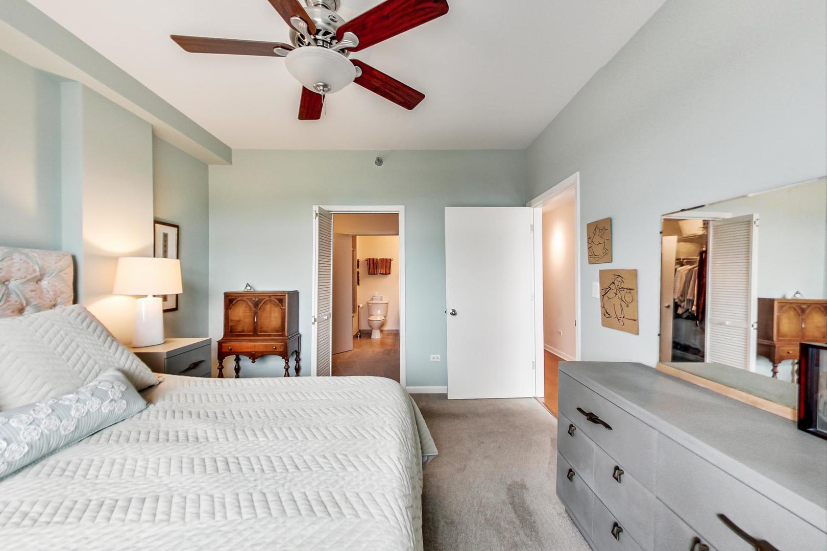 225 South Sangamon Street, Unit 809 Chicago, IL 60607 - Photo 28 of 34 a bedroom with a bed and wooden floor