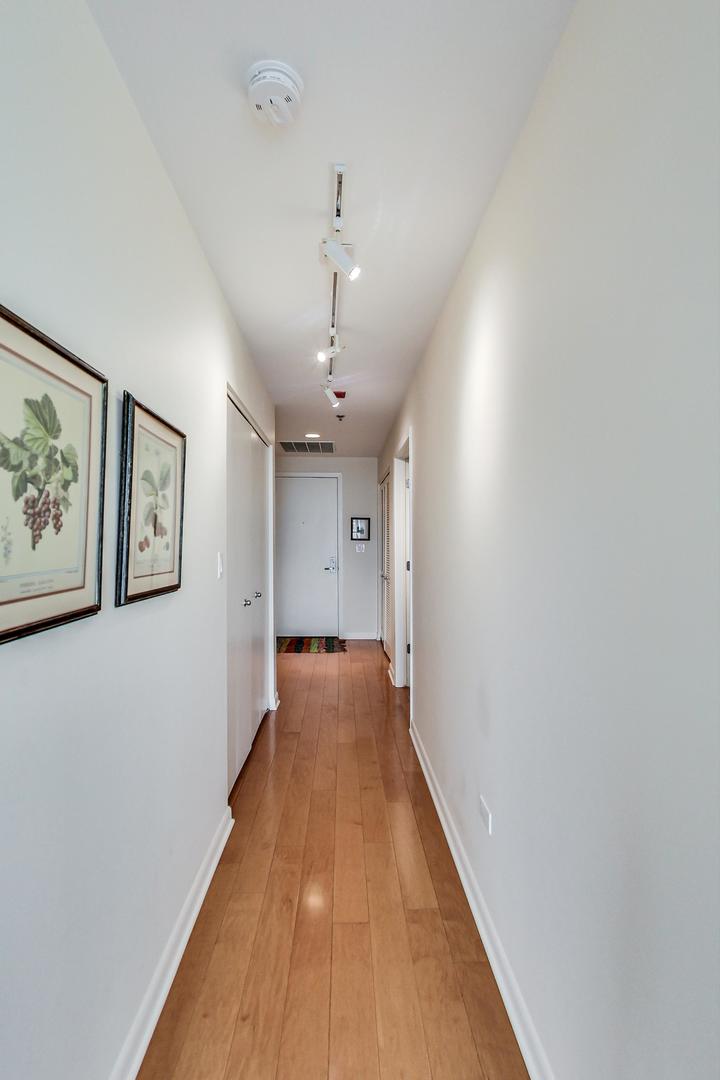225 South Sangamon Street, Unit 809 Chicago, IL 60607 - Photo 10 of 34 a view of a hallway with wooden floor