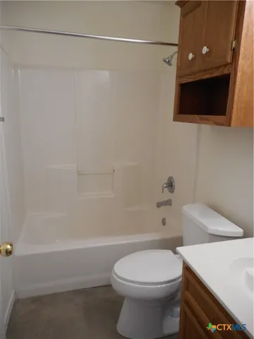 a bathroom with a toilet a sink and bathtub