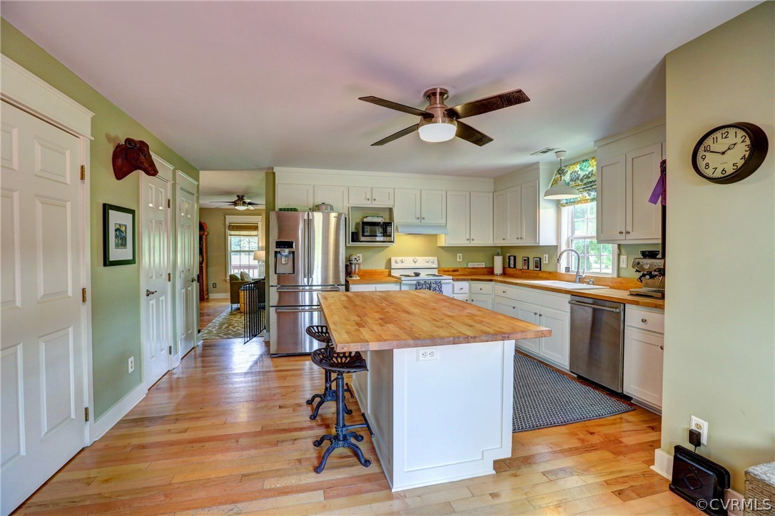 5226 North Warriner Road Richmond, VA 23231 - Photo 16 of 50 a large kitchen with stainless steel appliances kitchen island granite countertop a refrigerator a stove and a sink with granite countertops
