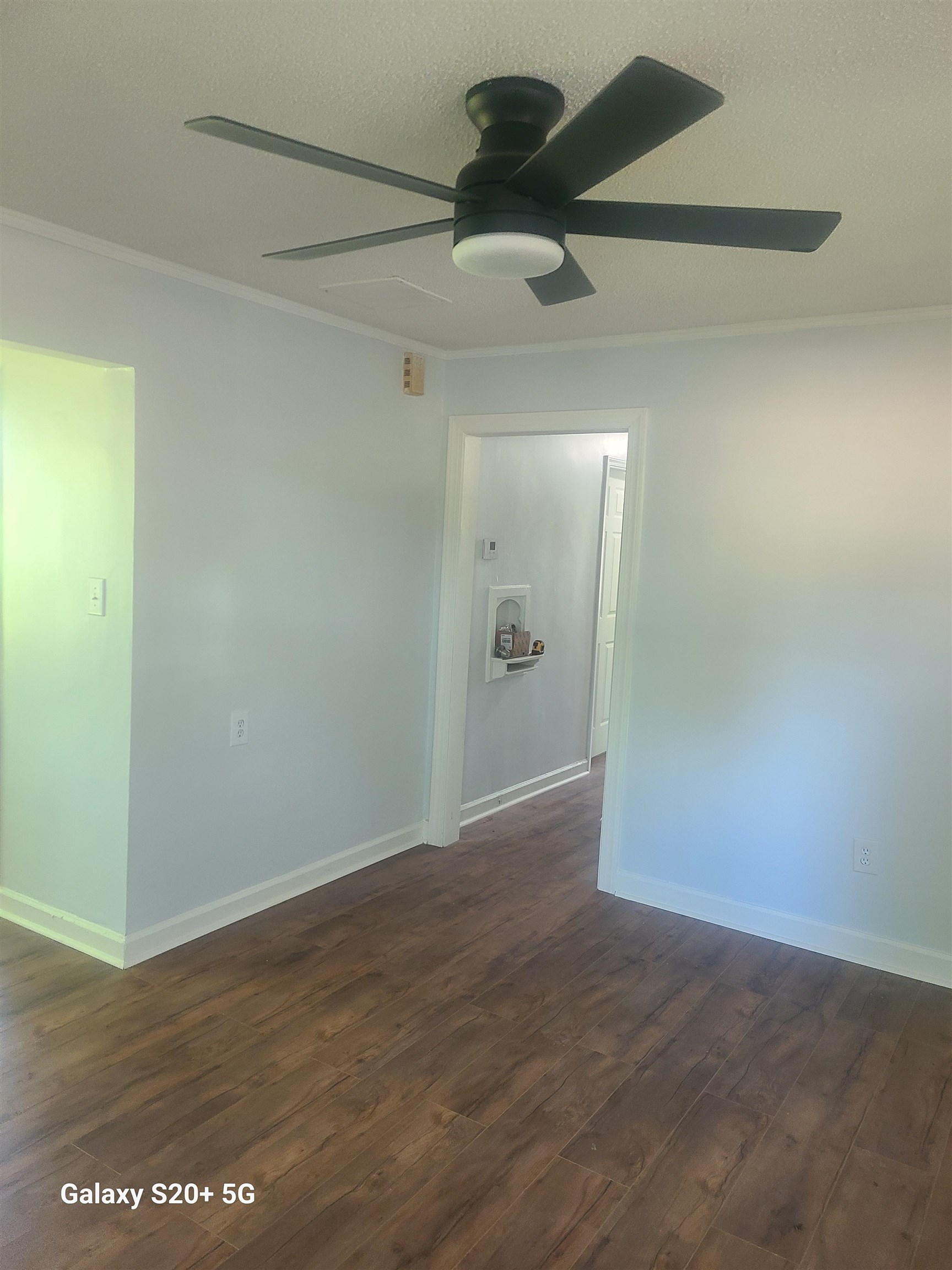 7960 Martha Road Millington, TN 38053 - Photo 5 of 9 an empty room with a ceiling fan and wooden floor
