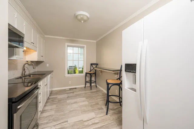 a kitchen with stainless steel appliances granite countertop a stove and a refrigerator