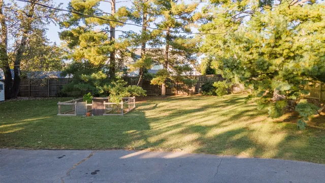 a view of yard with swimming pool and green space