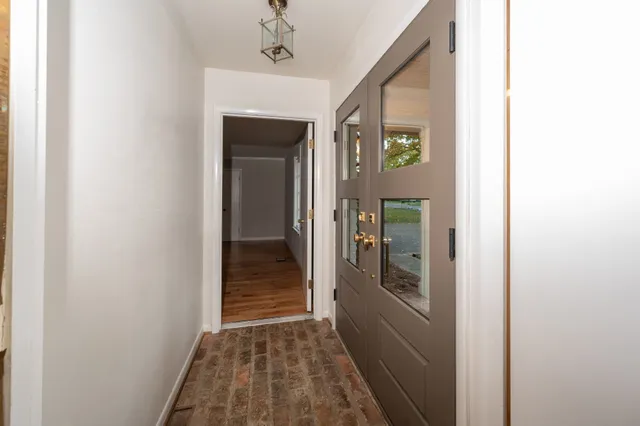 a view of a hallway view with wooden floor and staircase