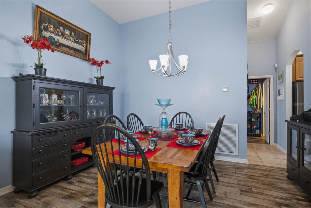 2423 Triggerfish Court Holiday, FL 34691 - Photo 13 of 71 a view of a dining room with furniture wooden floor and chandelier
