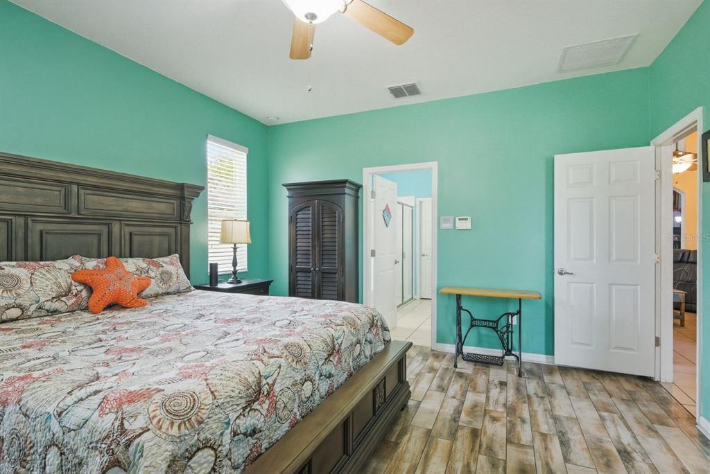 2423 Triggerfish Court Holiday, FL 34691 - Photo 25 of 71 a bedroom with a large bed and a chandelier