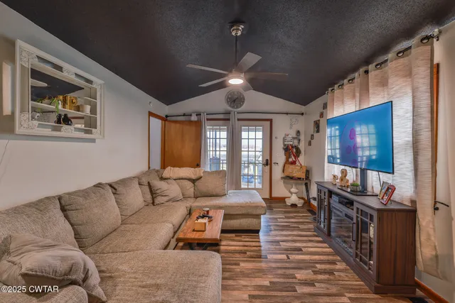 a living room with furniture and a flat screen tv