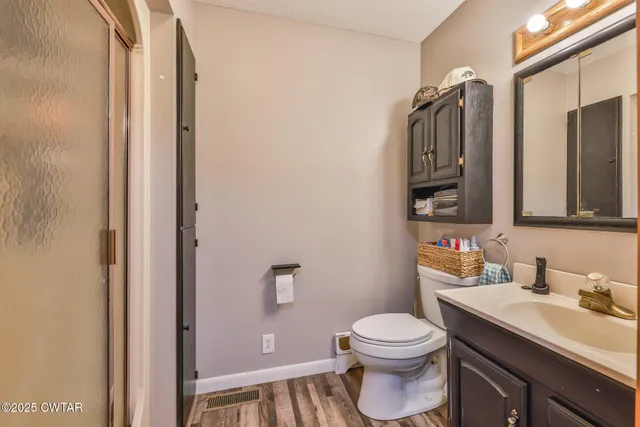 a bathroom with a toilet a sink and a mirror