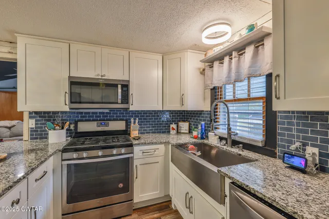 a kitchen that has a sink and a stove