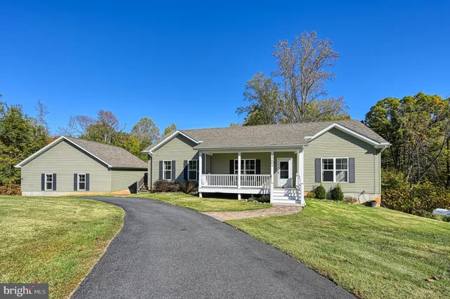 a front view of a house with a garden and plants