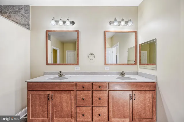 a bathroom with a double vanity sink and a mirror