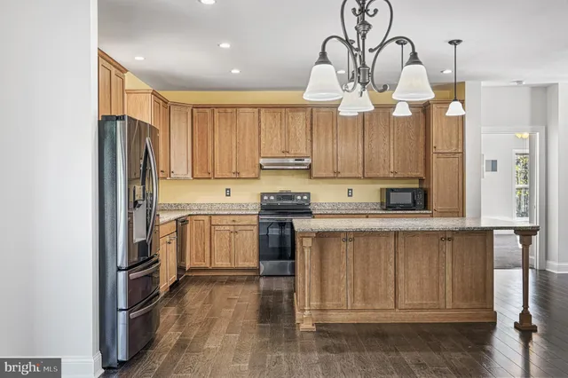 a kitchen with cabinets and stainless steel appliances