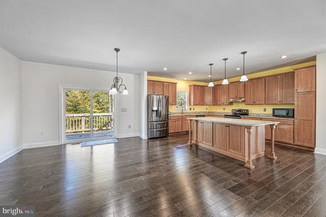 a large kitchen with white cabinets and stainless steel appliances