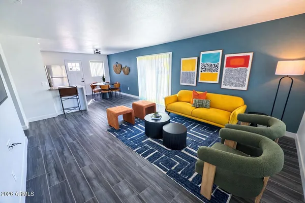 a living room with furniture and a wooden floor