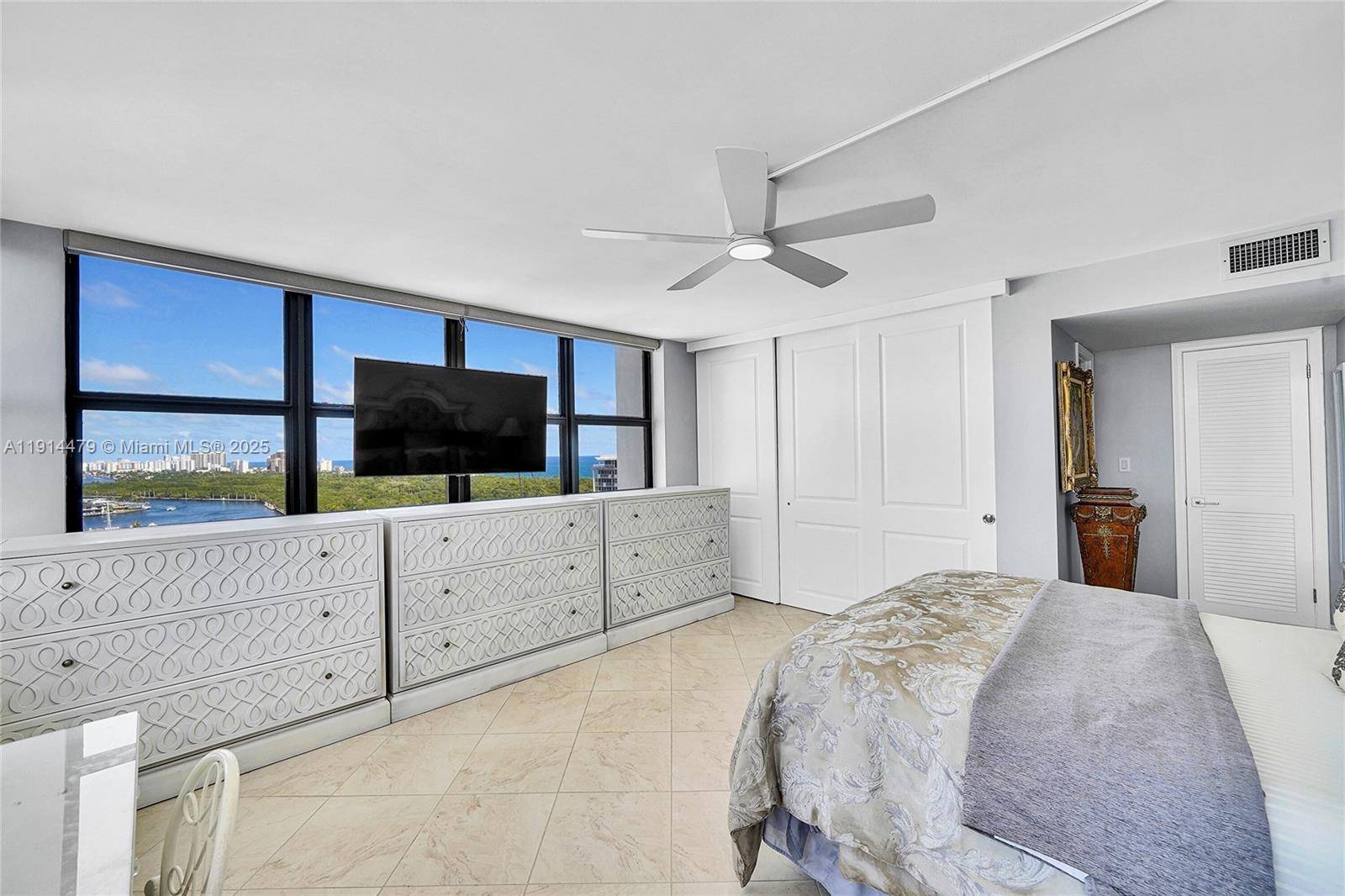 936 Intracoastal Drive, Unit 21A Fort Lauderdale, FL 33304 - Photo 20 of 52 a spacious bedroom with a large bed and a window