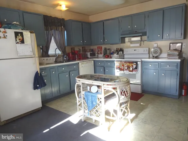 a kitchen with a sink a stove and cabinets