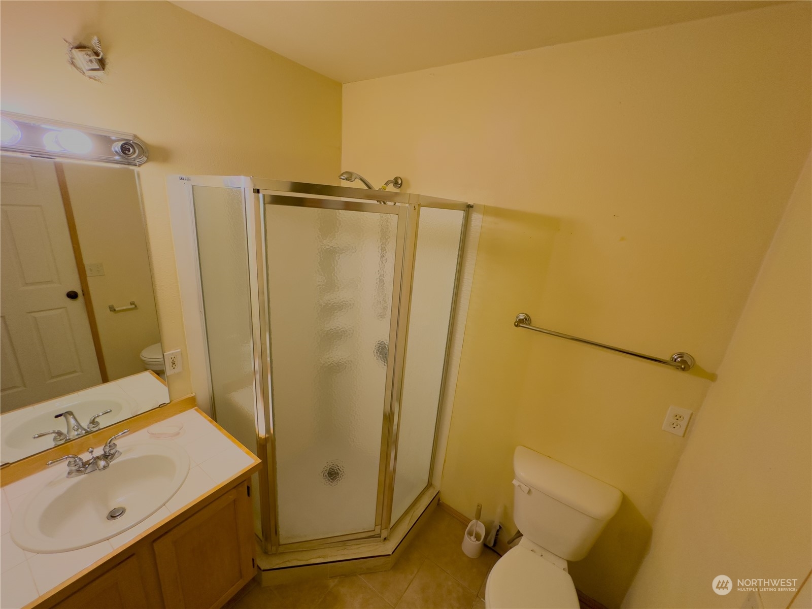 977 Graham Avenue Northeast Renton, WA 98059 - Photo 9 of 10 a bathroom with a sink a toilet a mirror and shower