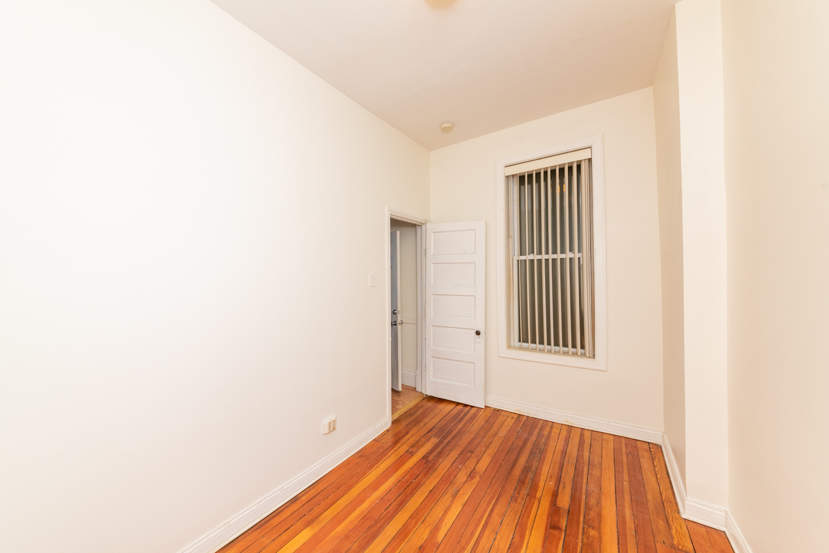 3300 North Racine Avenue, Unit 3 Chicago, IL 60657 - Photo 16 of 17 a view of an empty room with wooden floor and a window