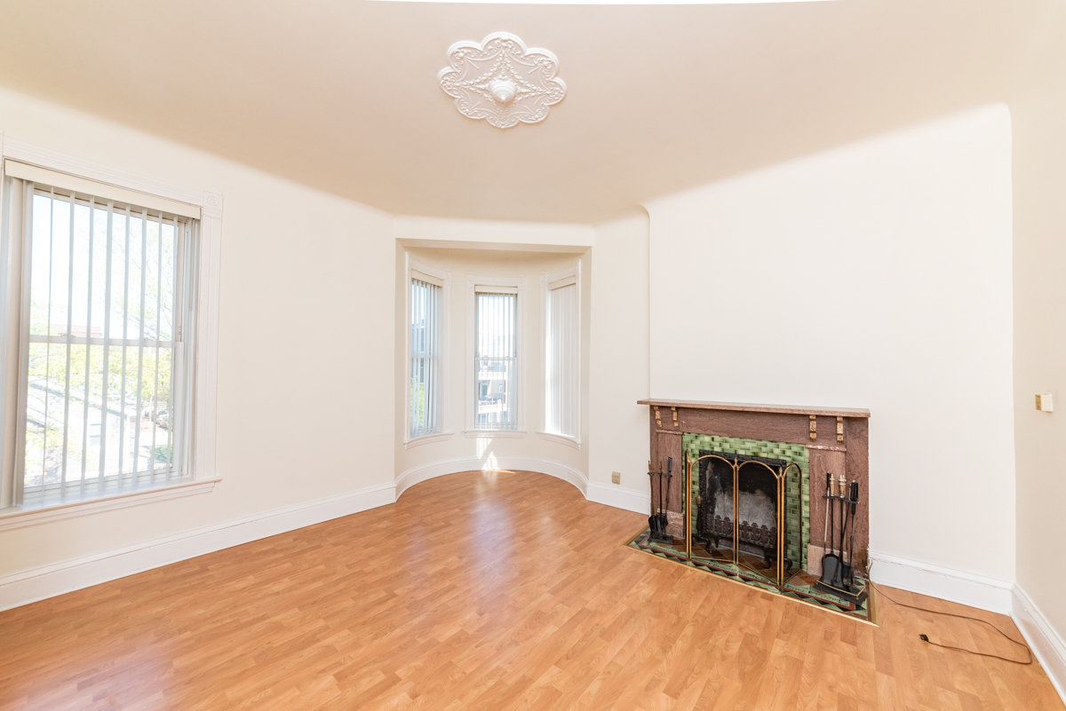 3300 North Racine Avenue, Unit 3 Chicago, IL 60657 - Photo 4 of 17 an empty room with windows and fireplace