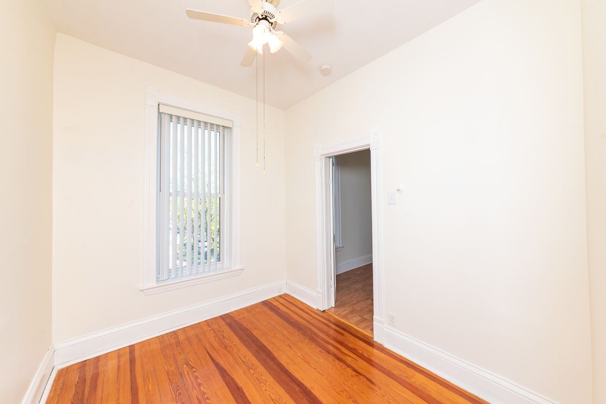 3300 North Racine Avenue, Unit 3 Chicago, IL 60657 - Photo 7 of 17 a view of empty room with wooden floor and fan