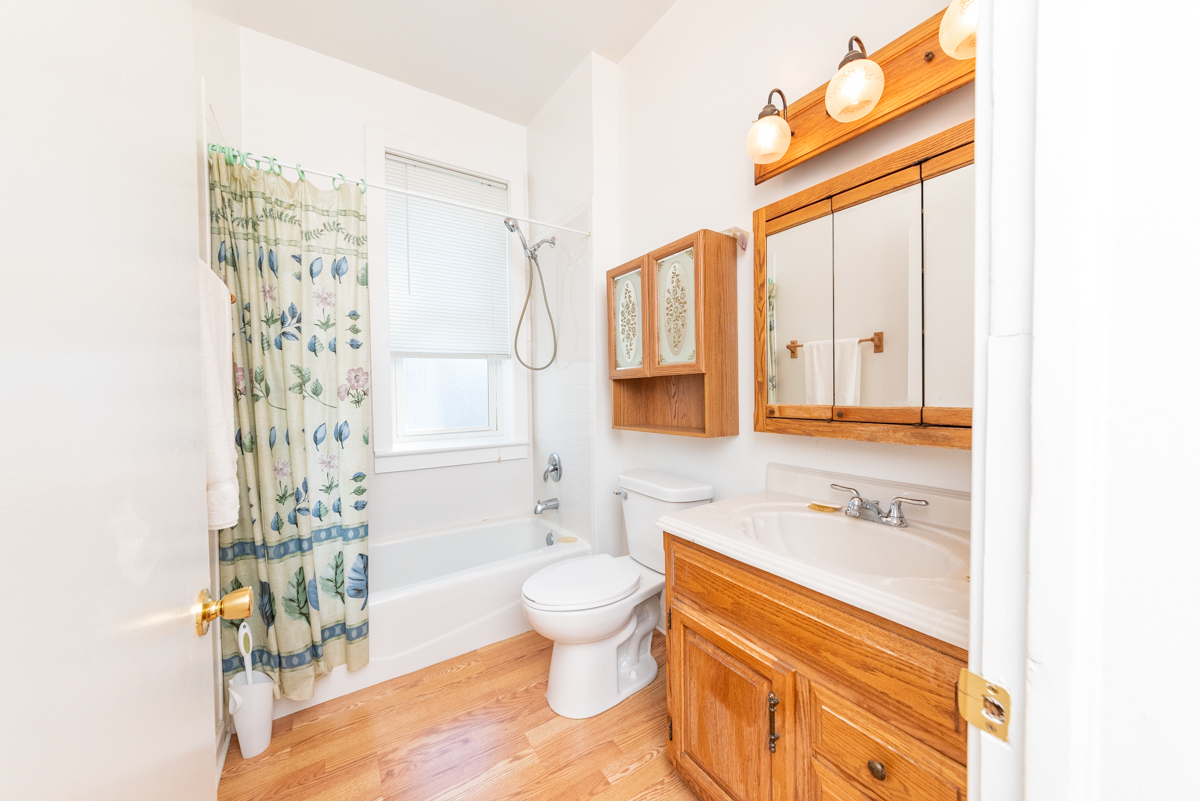 3300 North Racine Avenue, Unit 3 Chicago, IL 60657 - Photo 10 of 17 a bathroom with a granite countertop sink toilet and shower