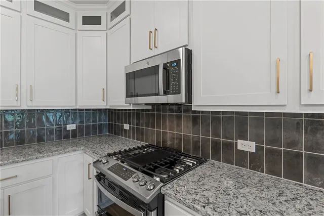a kitchen with a sink chandelier and wooden floor