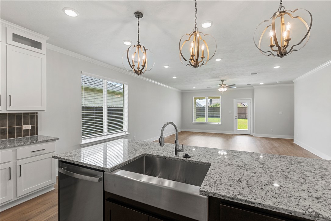 5008 Toscana Loop Bryan, TX 77802 - Photo 13 of 33 a kitchen with stainless steel appliances granite countertop a sink and stove top oven