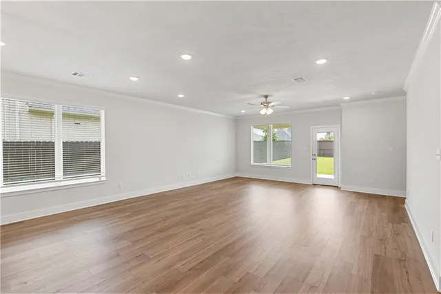 a view of kitchen with kitchen island wooden floor and center island