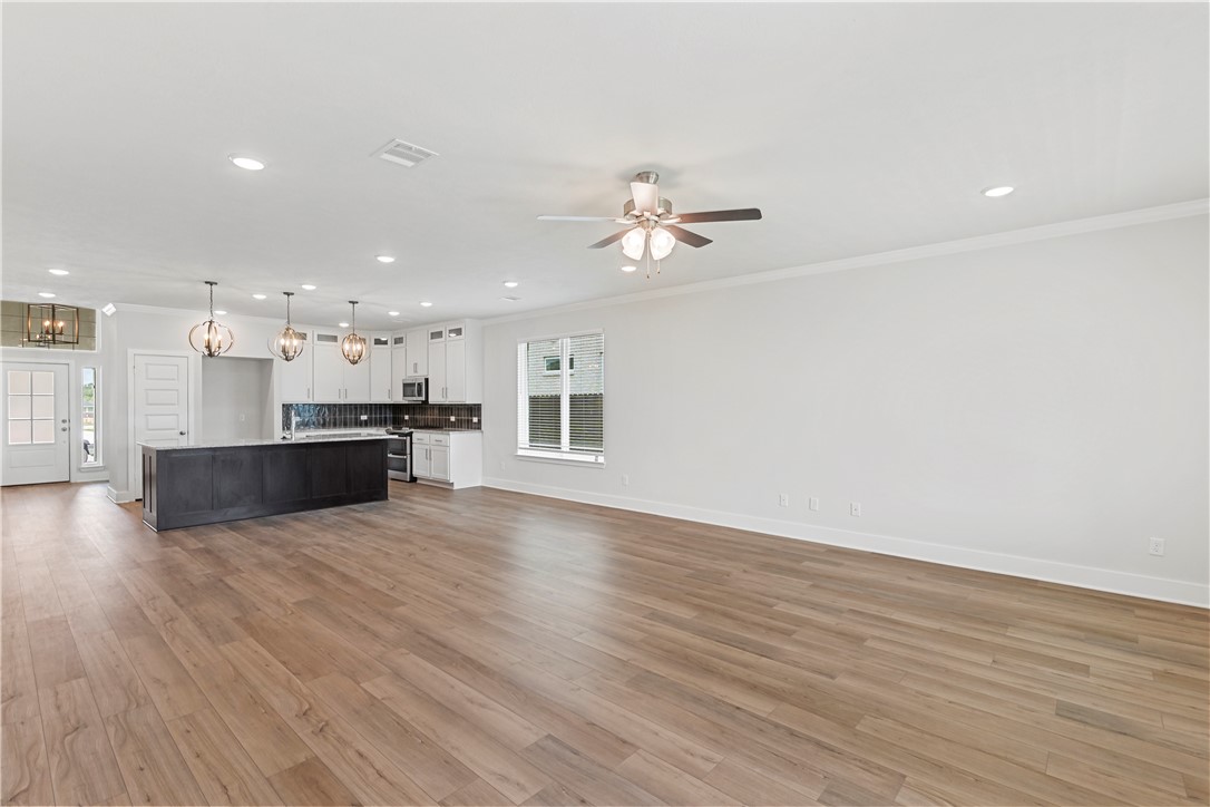 5008 Toscana Loop Bryan, TX 77802 - Photo 15 of 33 a view of kitchen with kitchen island wooden floor and center island