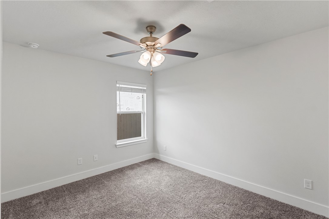 5008 Toscana Loop Bryan, TX 77802 - Photo 19 of 33 an empty room with windows and fan