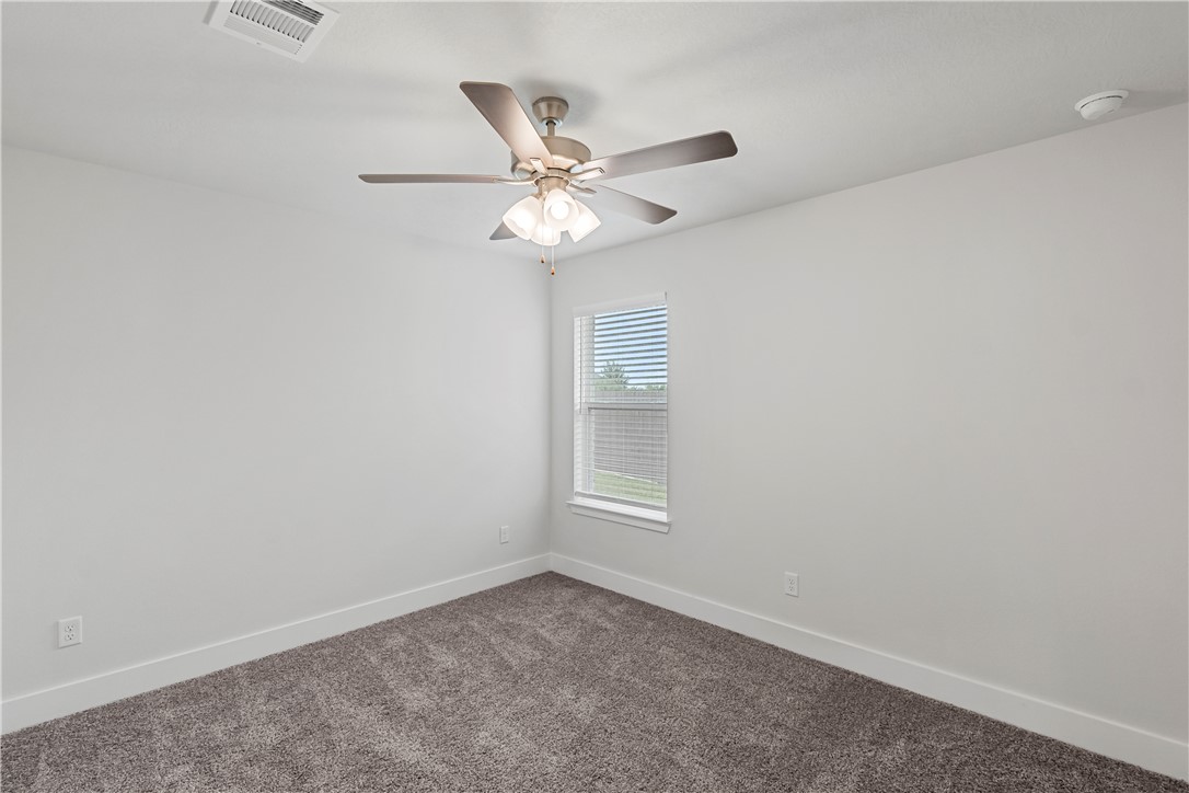 5008 Toscana Loop Bryan, TX 77802 - Photo 22 of 33 an empty room with windows and fan