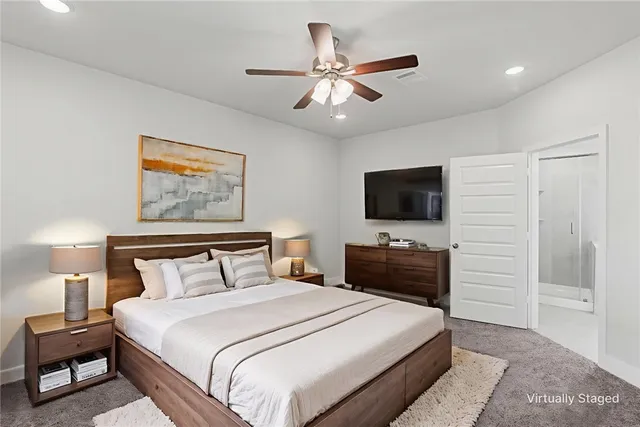 an empty room with closet and fan