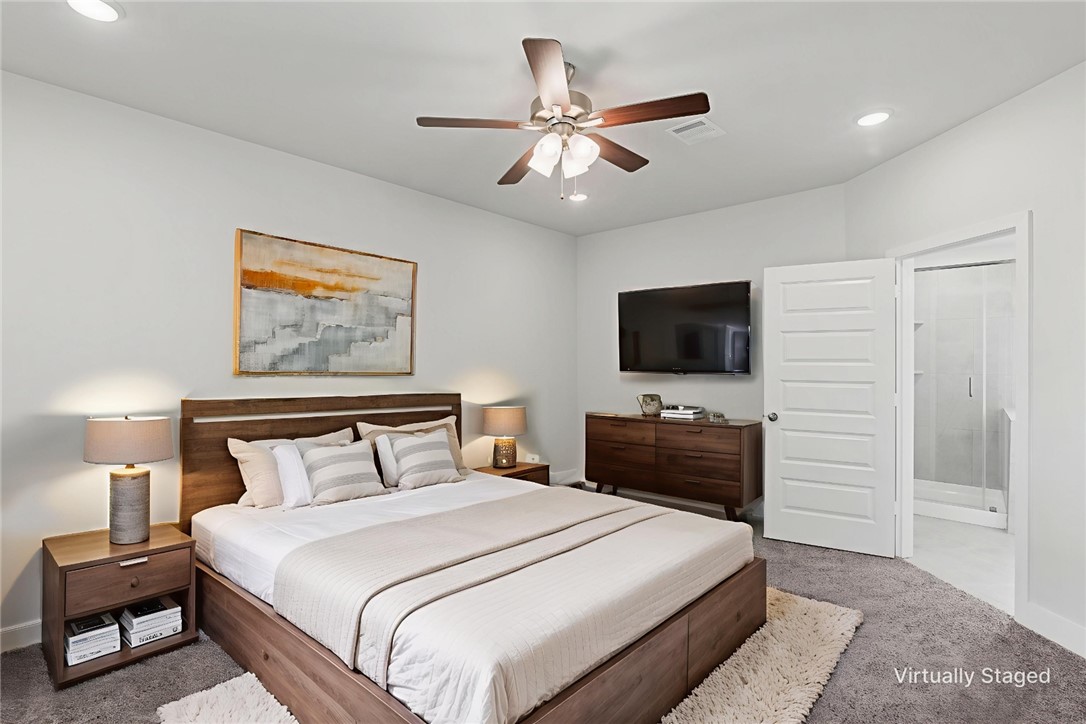 5008 Toscana Loop Bryan, TX 77802 - Photo 24 of 33 a bedroom with a bed and a flat screen tv