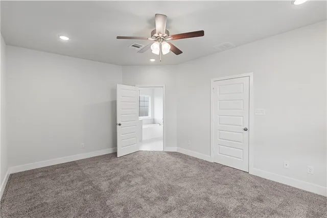 a spacious bathroom with a granite countertop sink and a mirror