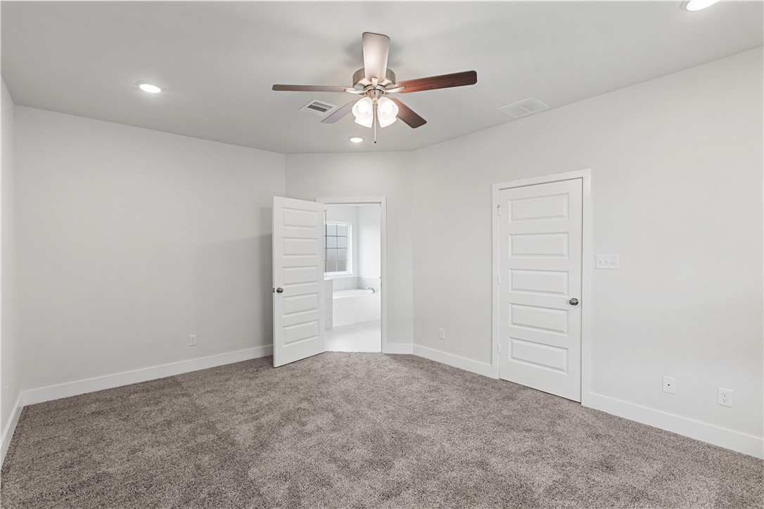 5008 Toscana Loop Bryan, TX 77802 - Photo 25 of 33 an empty room with closet and fan