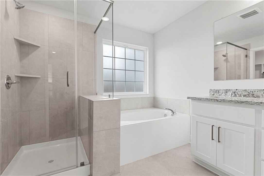 5008 Toscana Loop Bryan, TX 77802 - Photo 27 of 33 a bathroom with a tub sink and mirror