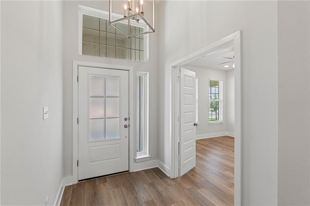 5008 Toscana Loop Bryan, TX 77802 - Photo 4 of 33 an empty room with wooden floor and windows