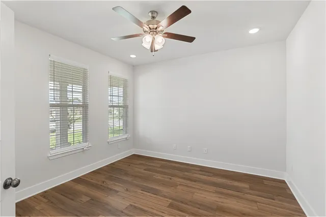 a kitchen with granite countertop a stove top oven a sink dishwasher and a oven with wooden floor