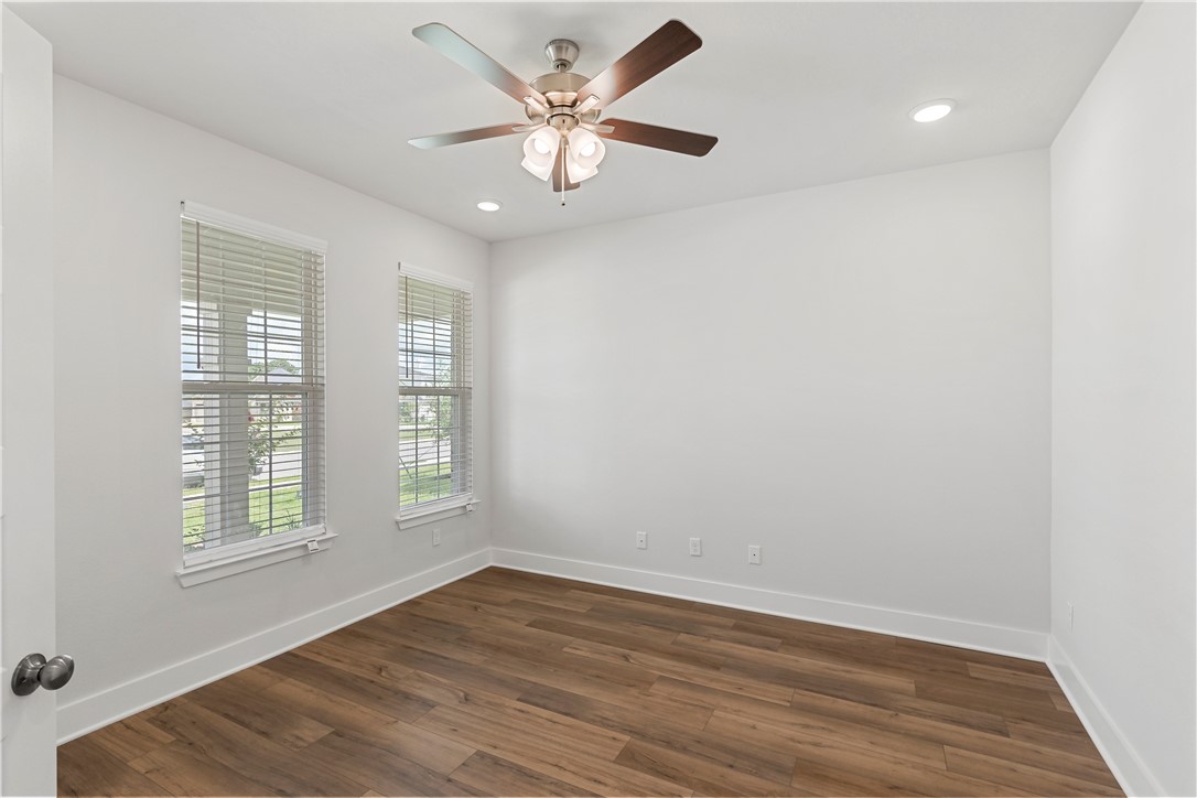 5008 Toscana Loop Bryan, TX 77802 - Photo 6 of 33 an empty room with wooden floor and windows