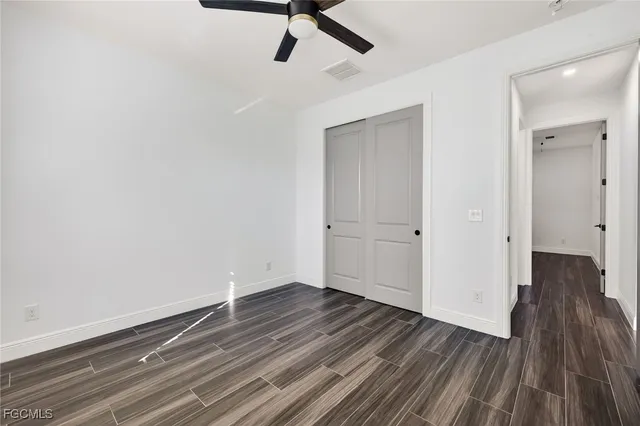 a view of a room with wooden floor and white walls