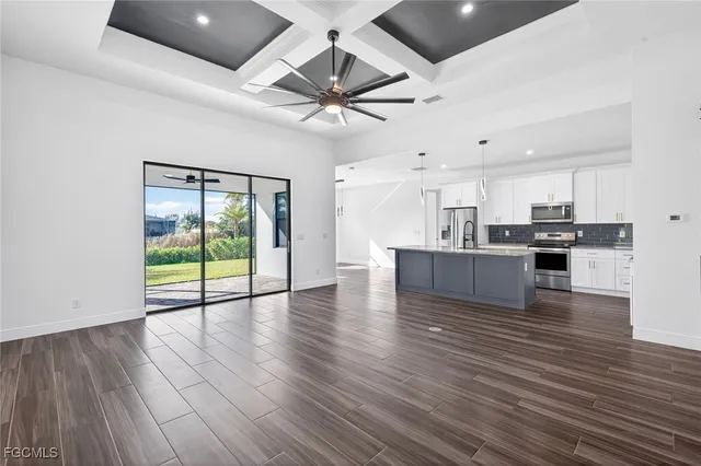 a view of kitchen with cabinets and wooden floor