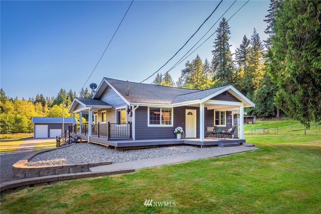 18724 Dubuque Road Snohomish, WA 98290 - Photo 4 of 38 a front view of a house with a yard table and chairs