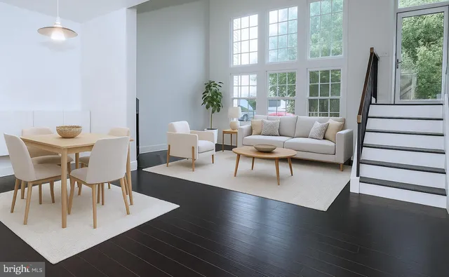 a living room with furniture wooden floor and a large window