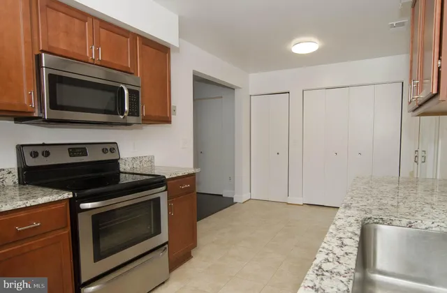a bedroom with a large bed and a potted plant