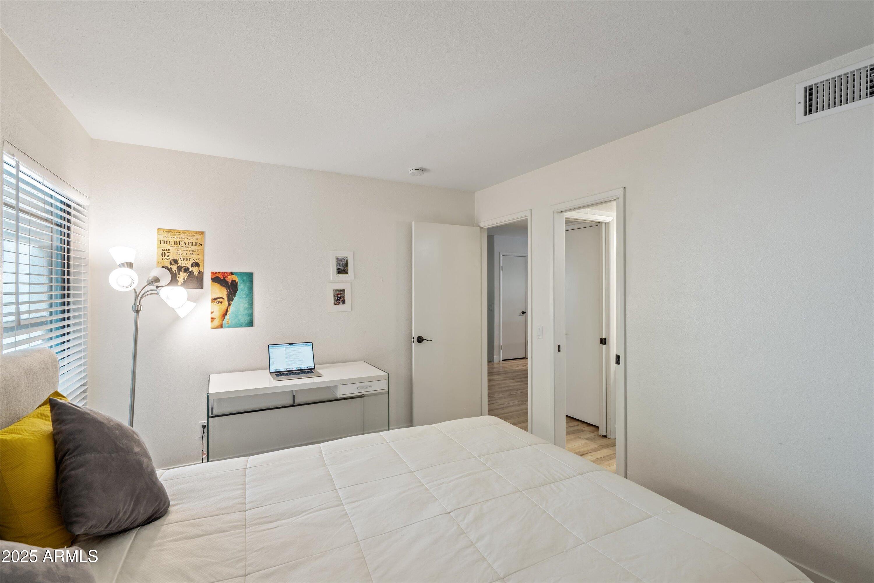 5201 North 24th Street, Unit 206 Phoenix, AZ 85016 - Photo 11 of 39 a bedroom with a white bed and white walls