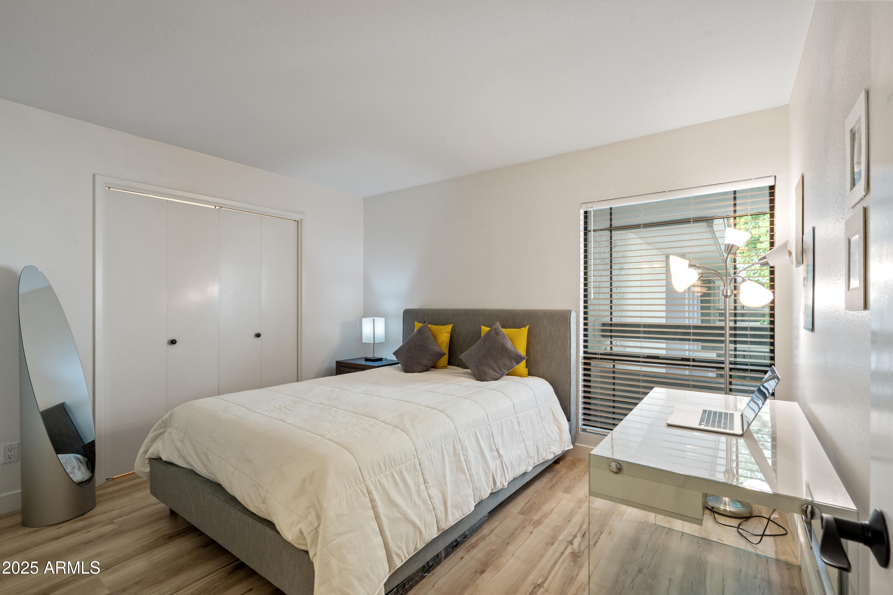 5201 North 24th Street, Unit 206 Phoenix, AZ 85016 - Photo 12 of 39 a bedroom with a bed and wooden floor