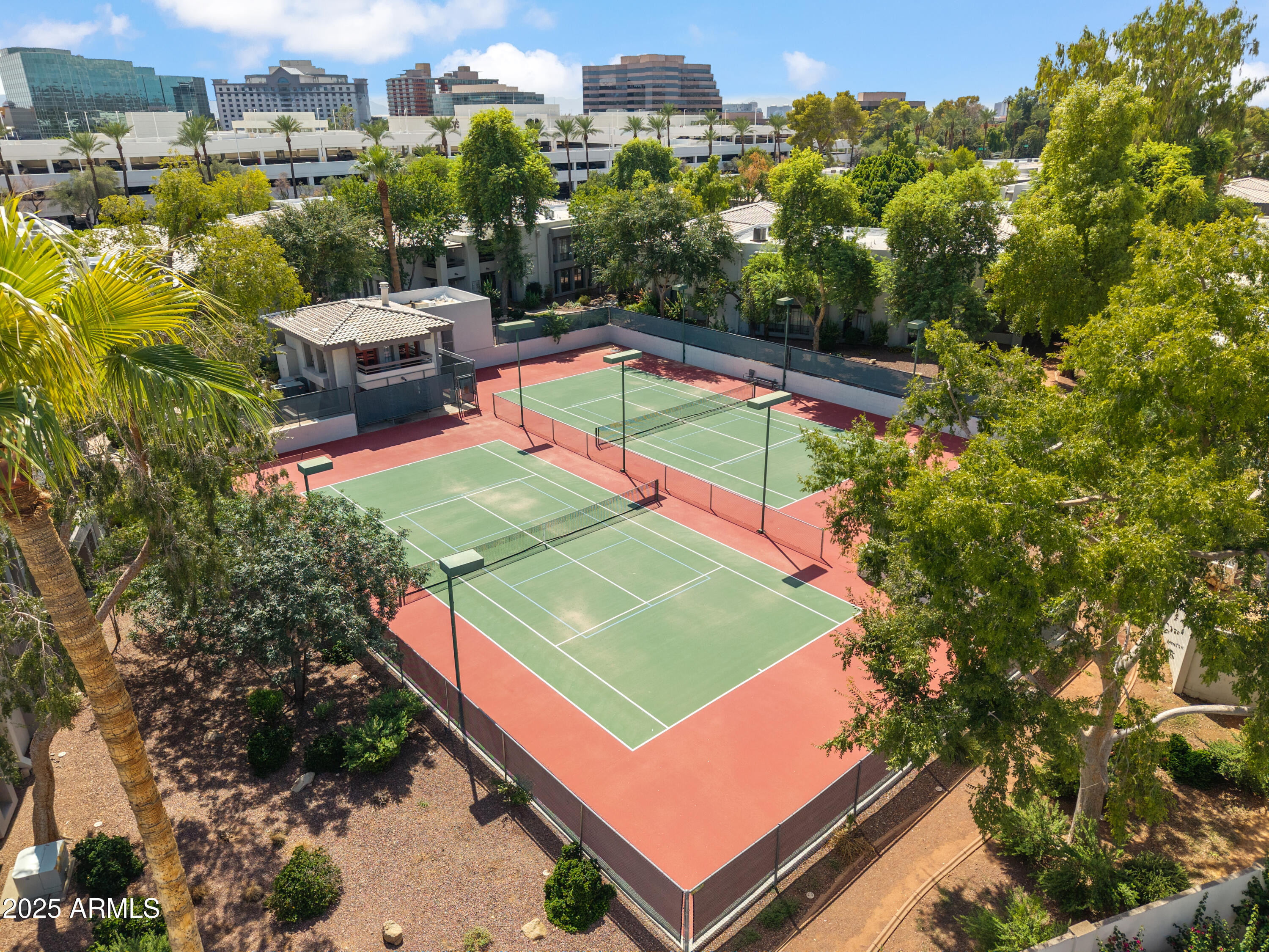 5201 North 24th Street, Unit 206 Phoenix, AZ 85016 - Photo 17 of 39 an aerial view of a tennis ground with a large pool