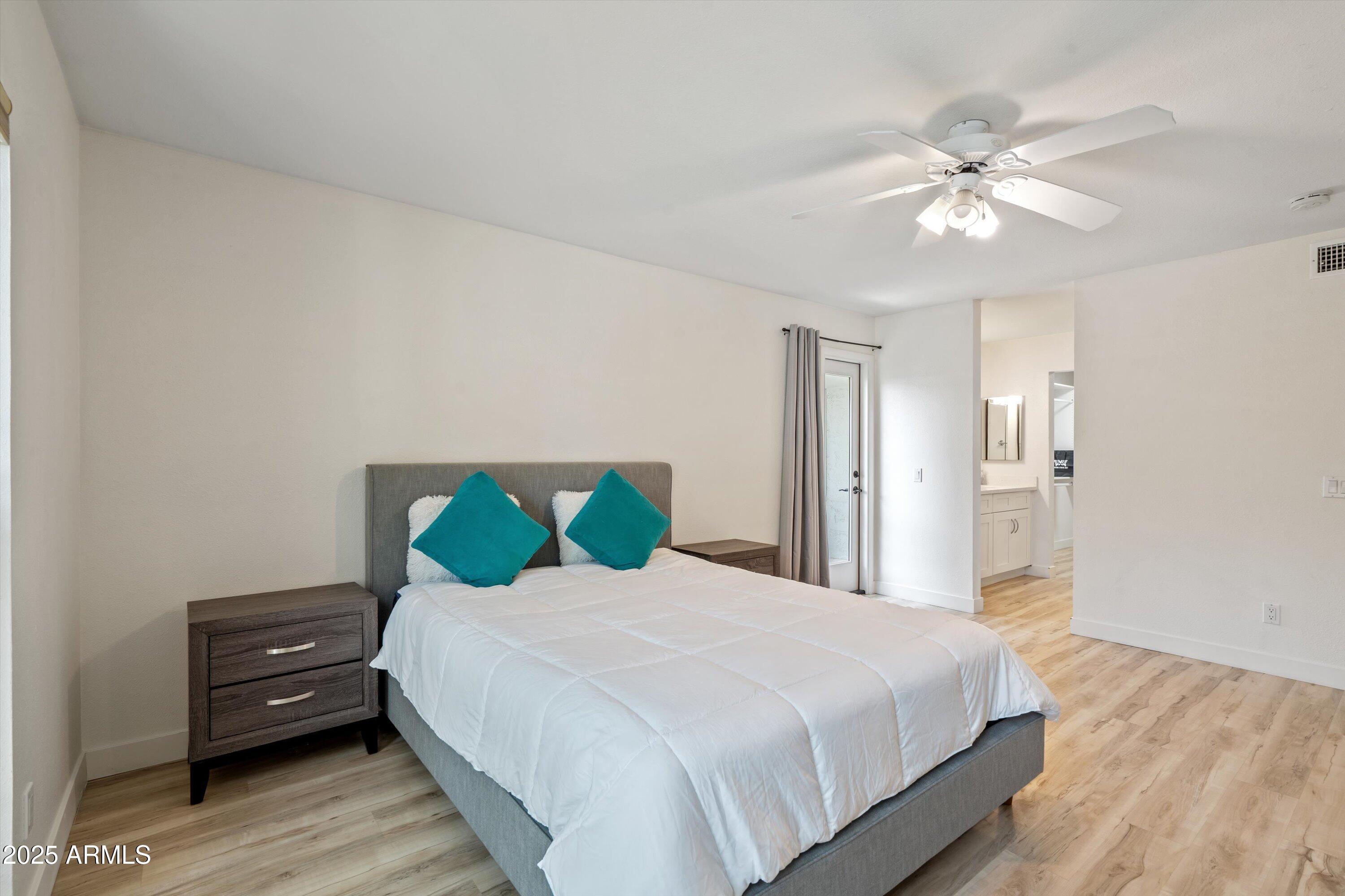 5201 North 24th Street, Unit 206 Phoenix, AZ 85016 - Photo 22 of 39 a bedroom with a bed and a chandelier