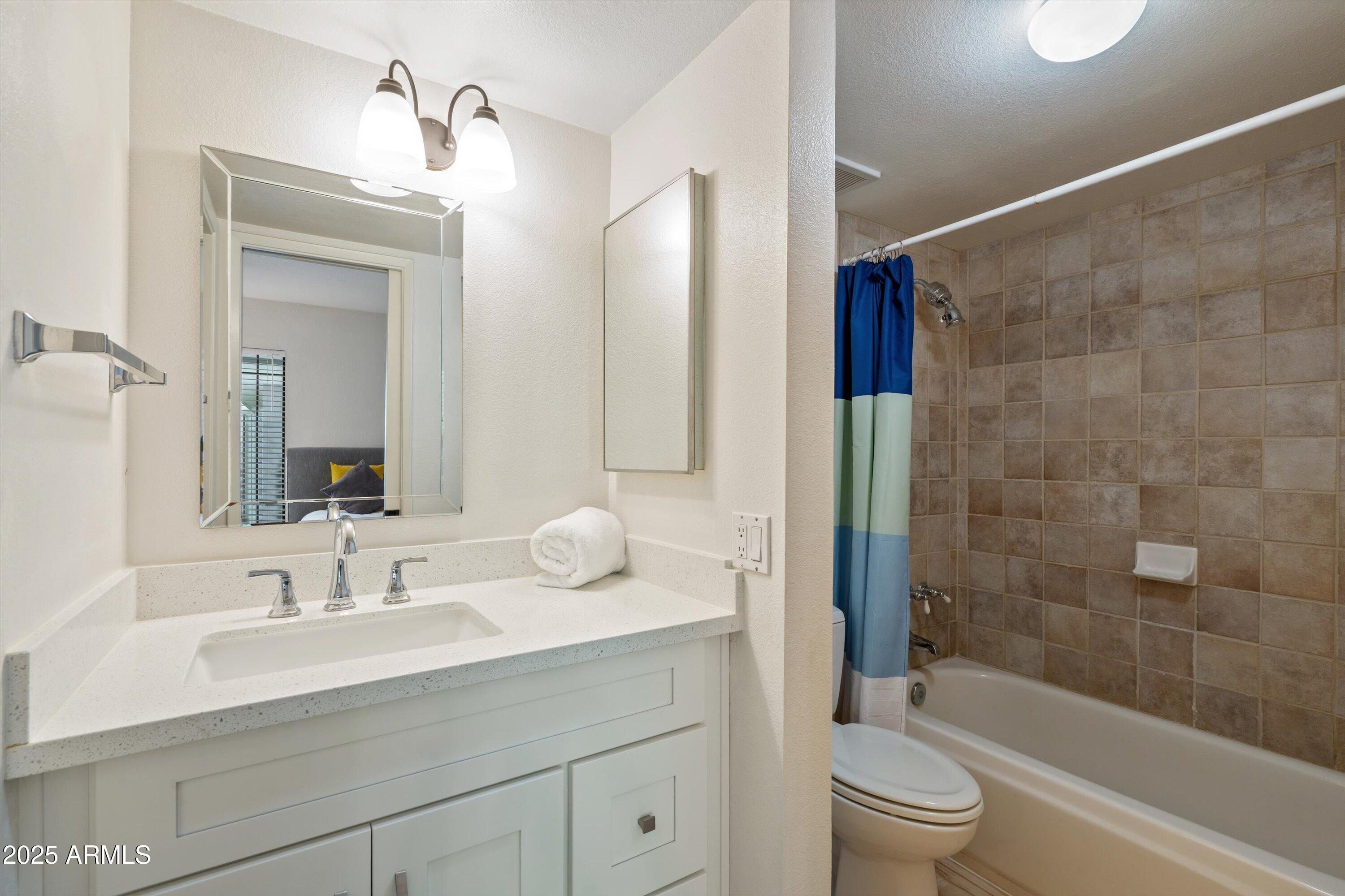 5201 North 24th Street, Unit 206 Phoenix, AZ 85016 - Photo 24 of 39 a bathroom with a sink a toilet and shower